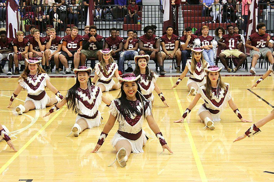Farmerettes slide into the splits in the middle of performance