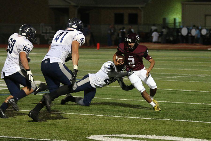 Senior kicker Kevin Vazquez (2) runs the ball after faking the punt.