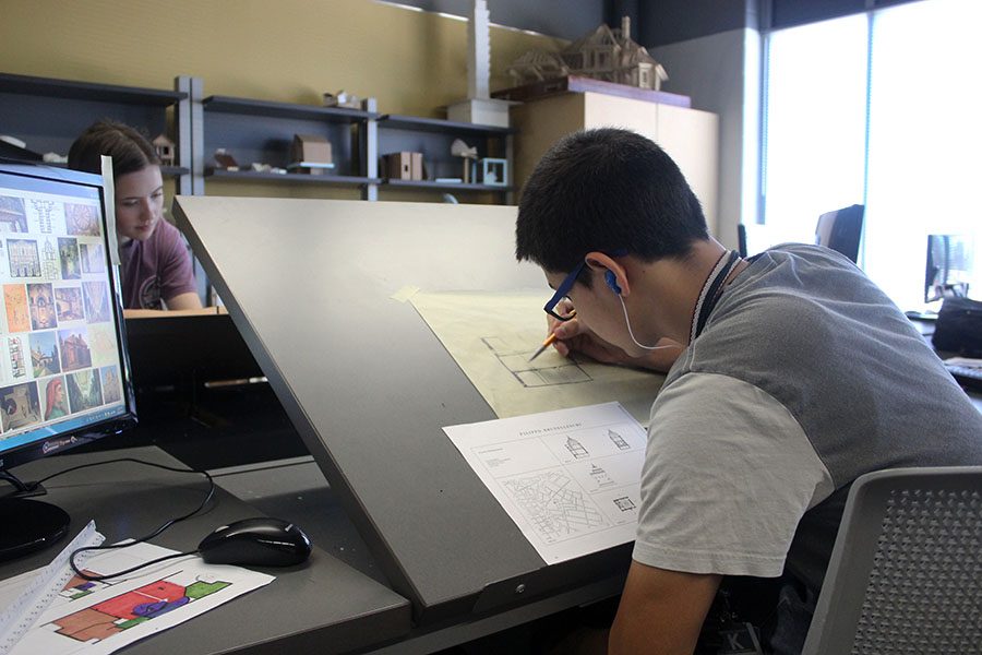 Sophomore Edwin Gutierrez works on his project for architecture while listening to his music.
