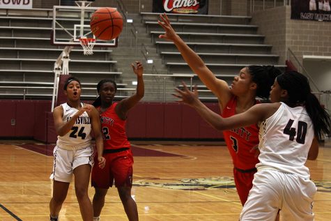 Senior Amani Alston (40) reaches for the ball after junior McKenzie Bowie (24) passes it.