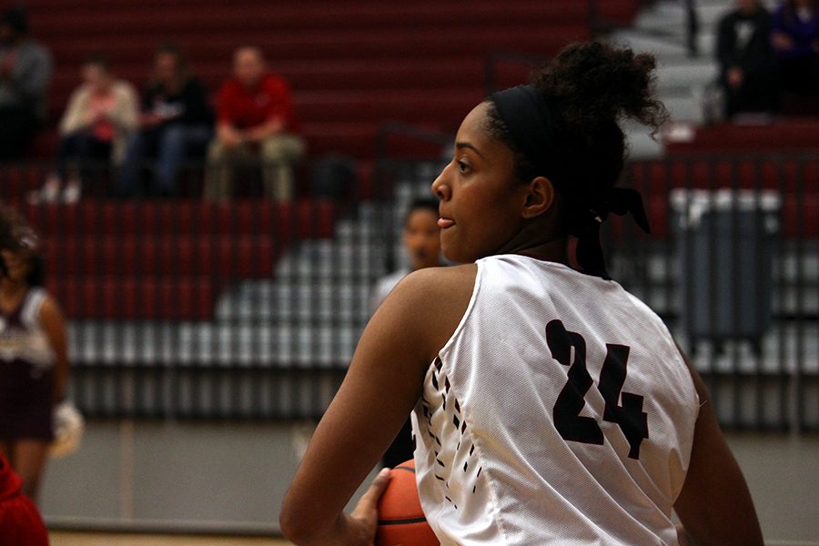 Junior McKenzie Bowie (24) scans the court for her teammates in order to pass the ball.