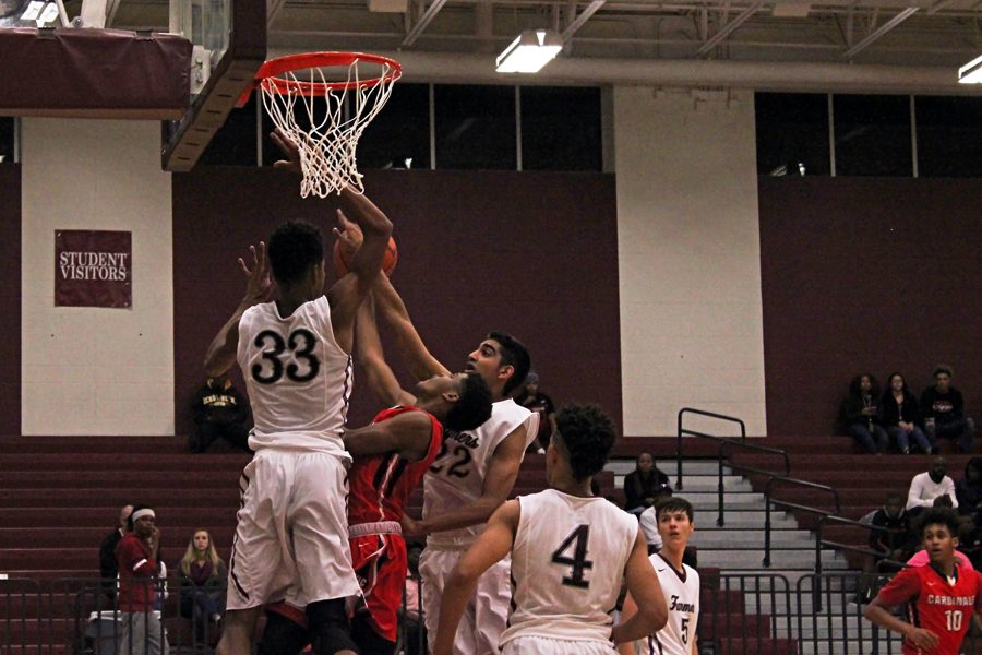 Junior Jydonn Griffith (33) and Junior Arshveer Mattu (22) go up for a rebound during the game on Tuesday, Dec. 6 against Irvng MacArthur.  