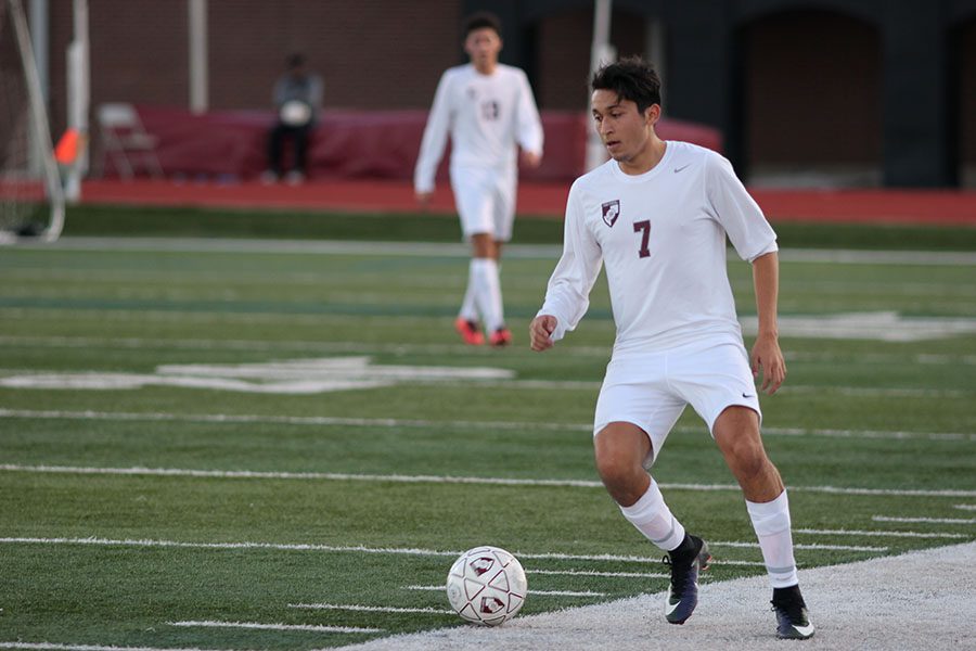 Senior Julio Gomez (7) keeps the ball inbound as he takes it up the field during the Keller Central game on Friday, Jan 20.