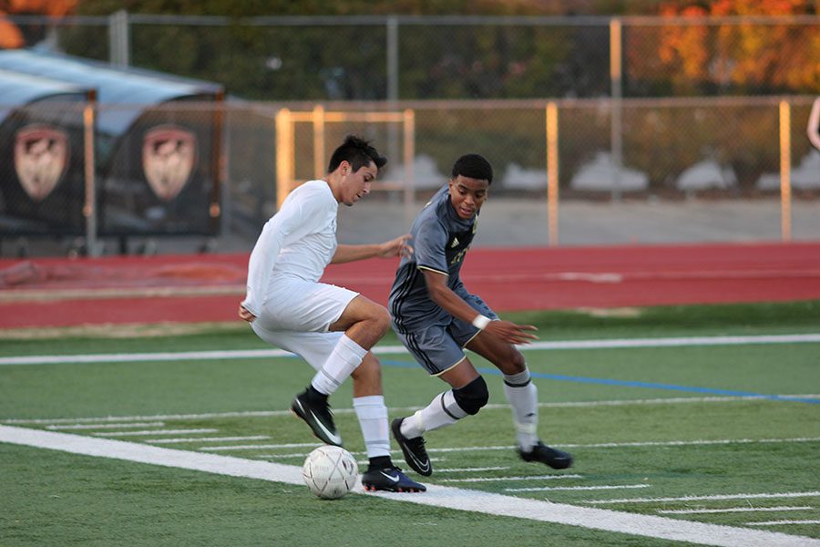 Senior Julio Gomez (7) pulls back the ball in an effort to make the Keller Central player unable to get to it during the game on Friday, Jan. 20.
