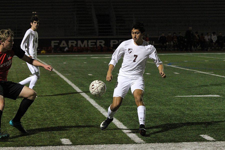 Senior Julio Gomez (7) intercepts the ball from a Marcus player.