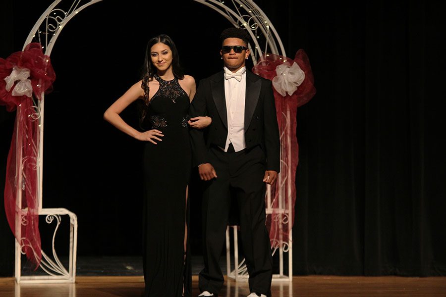 Senior Abigail Jimenez and junior Demondrick Hunter stop to let the audience take in the dress and suit.