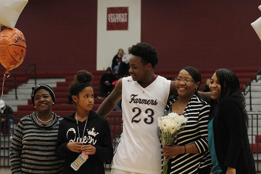 Senior Patrick Bethea and his family get ready for a picture at Senior Night.