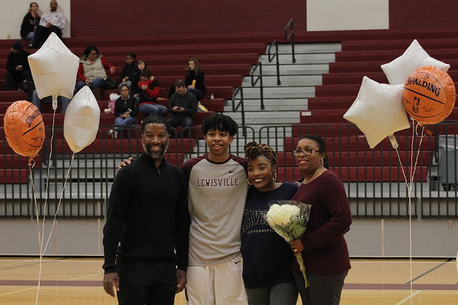 Senior Marcus Jefferson poses with his family for a picture. 