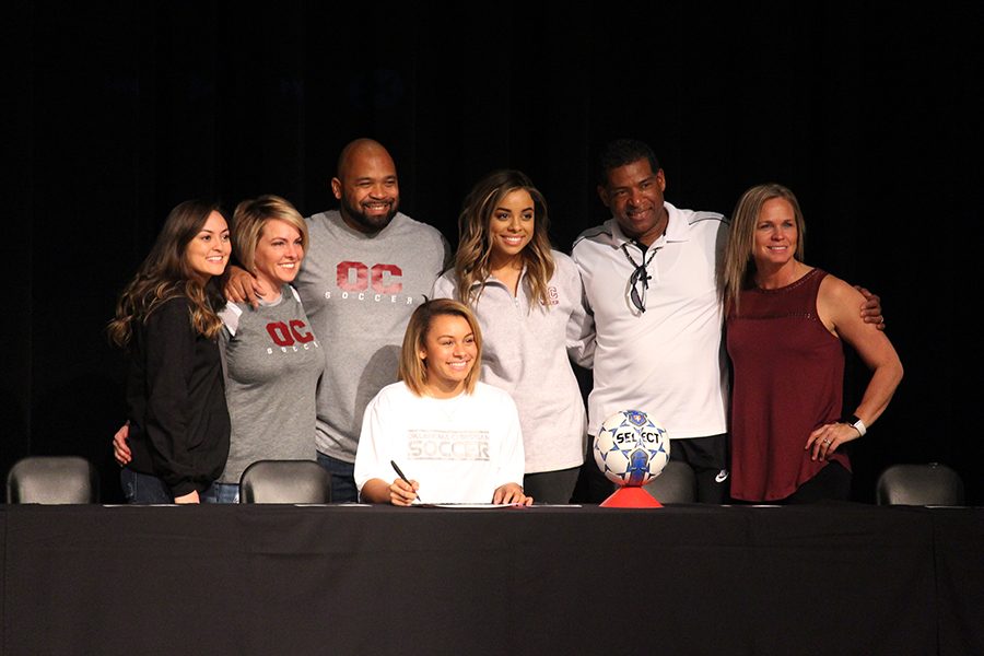 Myah Buhler poses with her family and coach after signing to Oklahoma Christian University for soccer.