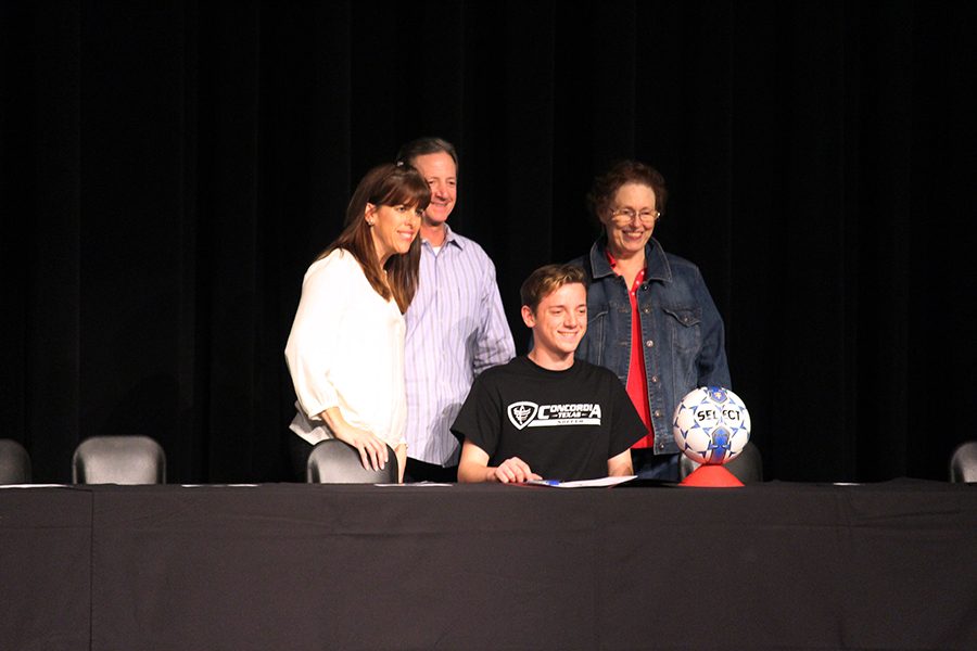 Brandon Barrows smiles with his family as he signs to Concordia University of Austin for soccer.