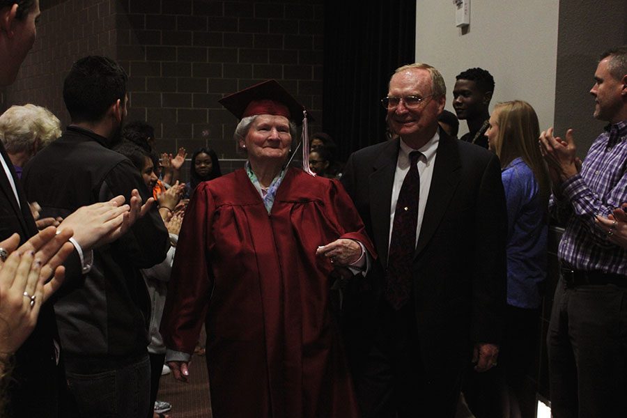 Frankie Sprabary and her son Paul Sprabary make their way through the tunnel of students cheering after the ceremony.