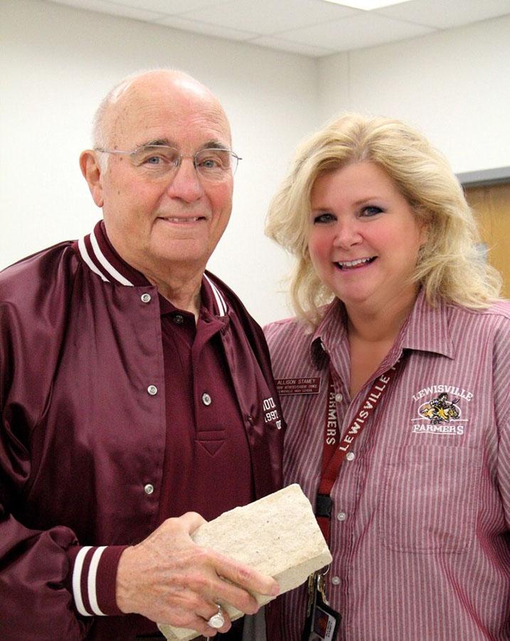 Former principal Doug Killough and StuCo adviser Allison Stamey pose for a photo with a brick from the old school building after the new one was built. Photo courtesy of Allison Stamey.