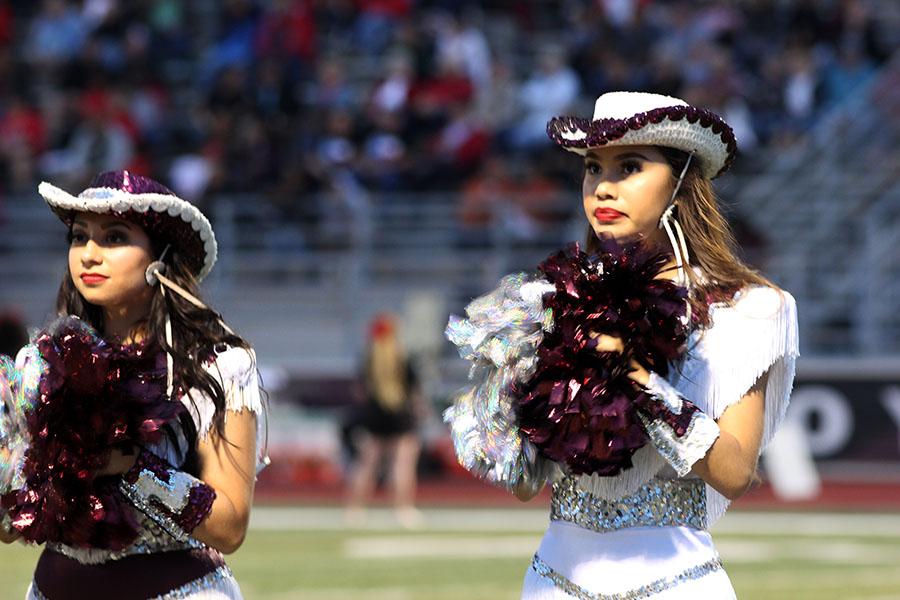 Junior Farmerettes Adriana Rodriguez and *name* wait for the game to begin.