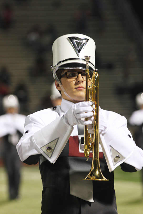 Junior Tyler Guillory plays his trumpet during the halftime show.