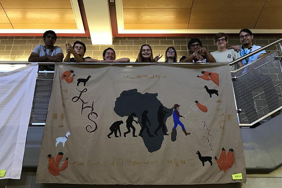 Members of Academic Decathlon show off their sheet for homecoming week. The sheet represented Africa, which is this years current theme.