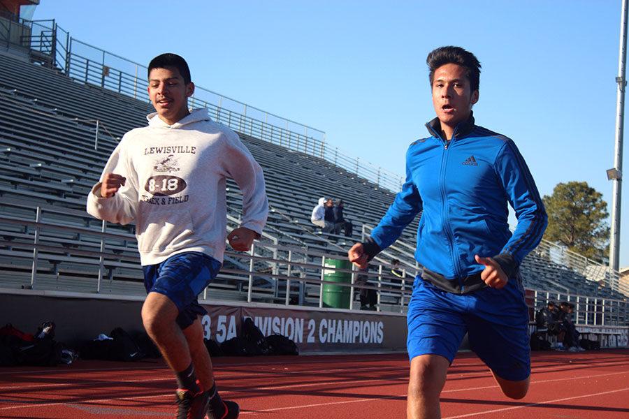 Freshman Kevin Vazquez and sophomore Bryan Hernandez run the track during practice on Wednesday, Feb. 7.