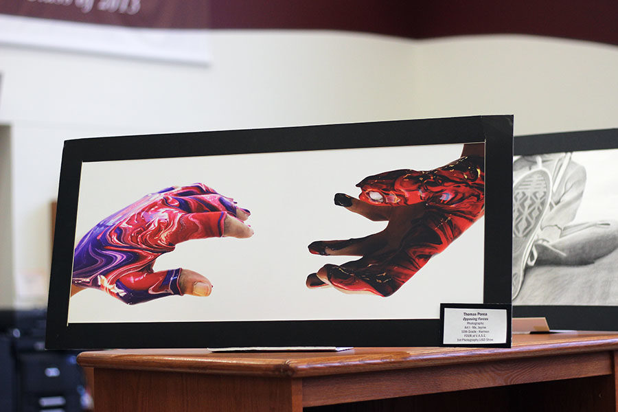 Sophomore Thomas Poreas photograph Opposing Forces is shown off at the art show.