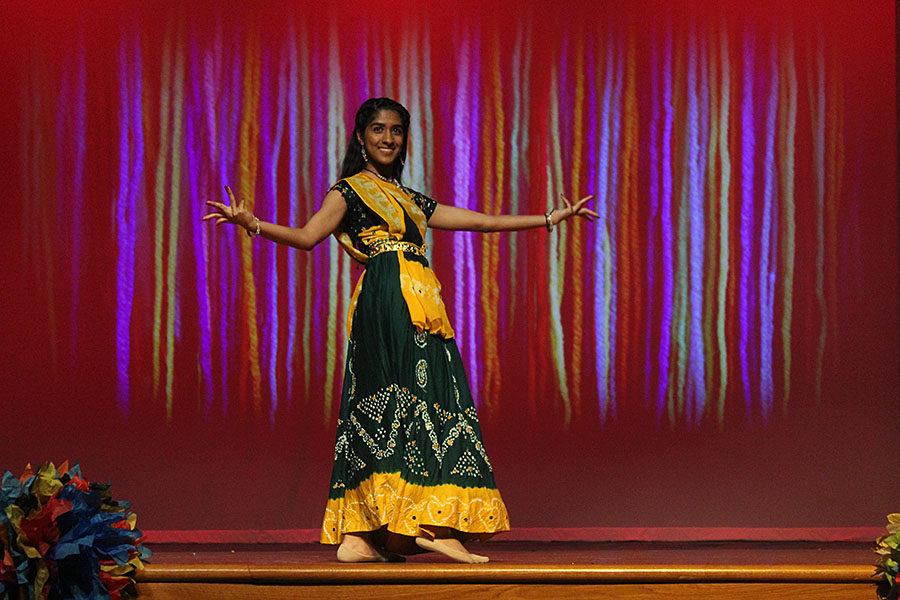 Senior Esha Harish dances to the Indian music toward the middle of the stage.
