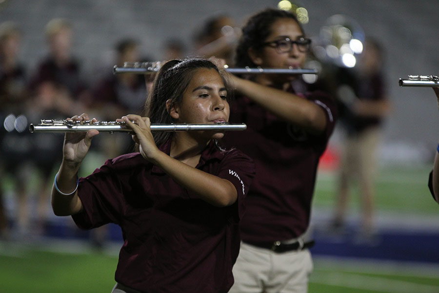 Junior Brianna Guerra plays her flute during the halftime show at the football game against McKinney Boyd on Thursday, Sept. 13.