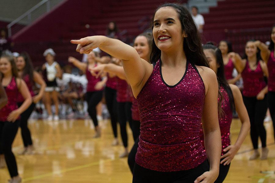 Junior Farmerette lieutenant Taylor Dill smiles at the crowd during the show.