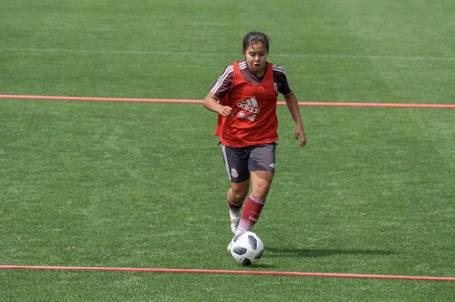 Athalie Palomo dribbles the ball down the field in Mexico. Courtesy of La Selección.