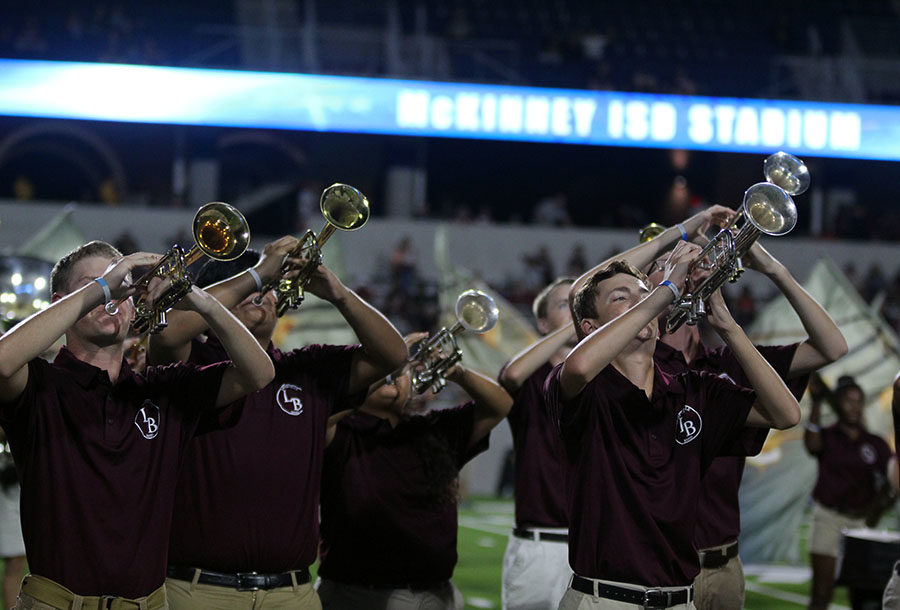 The trumpet section performs the bands halftime show, I Am Water, during the away game at McKinney Stadium on Thursday, Sept. 13.