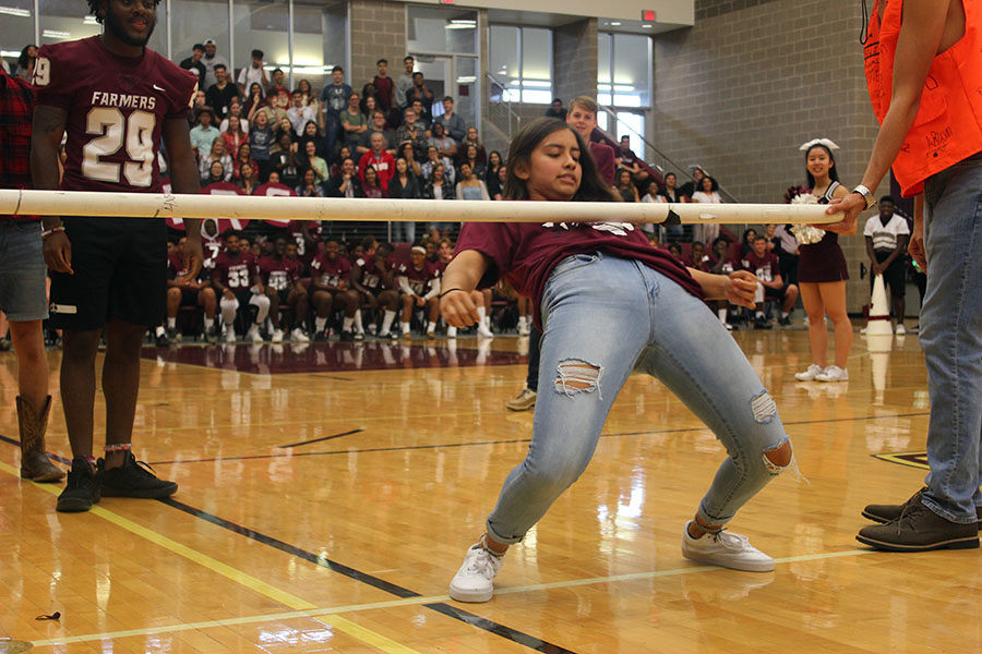 Junior Audrey Rodriguez attempts to do the limbo.