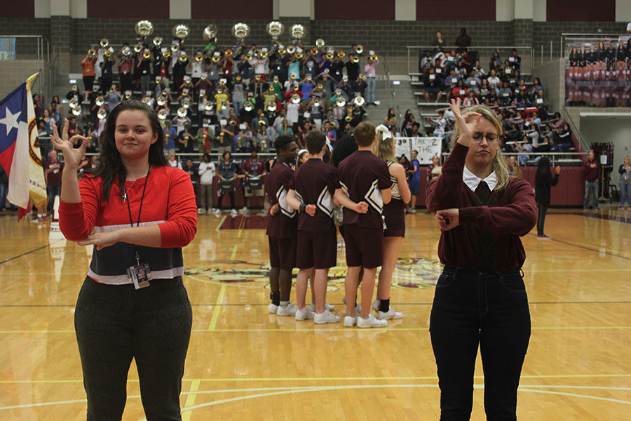 Seniors Emily Godwin and Maggie Russell sign the National Anthem.