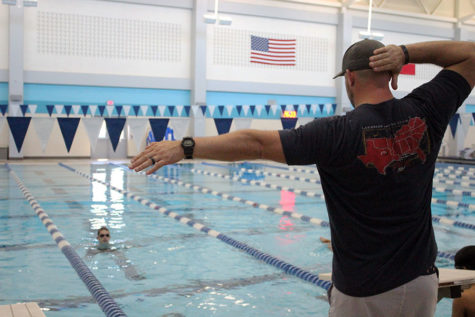 Head swim coach Craig Harris demonstrates the right movement for a cutaway.