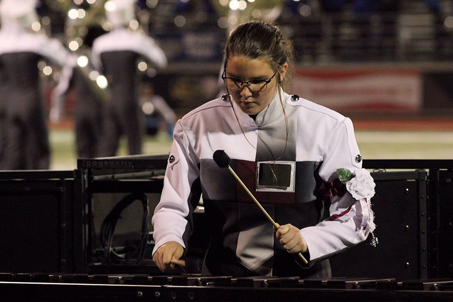 Senior Elizabeth Shoven plays the xylophone during the bands halftime show, I Am Water.