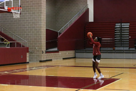Junior Sydney Savage practices her jumpshot at the top of the paint during morning practice on Wednesday, Nov. 14.