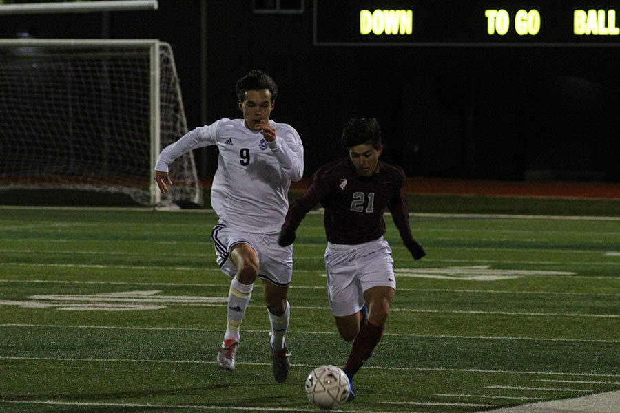 Junior forward Ethan Carbajal (21) runs after the ball in effort to regain control of it.