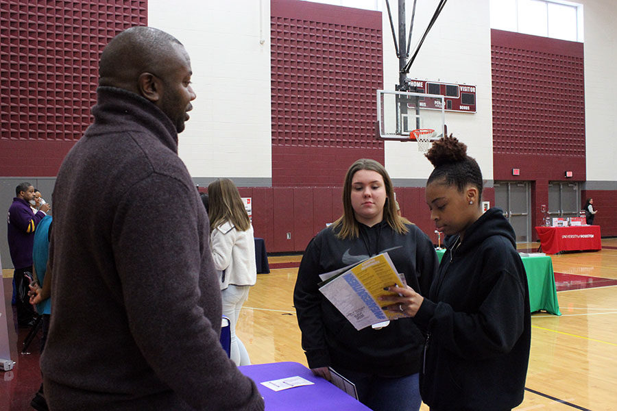Senior Clenasia Anderson and junior Abby Harrison talk to transfer counselor Quinten D. Bates about Wiley College.