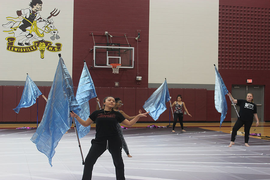 Senior Zaira Beltran rehearses the end of the performance with other winter guard members on Wednesday, Feb. 27. 