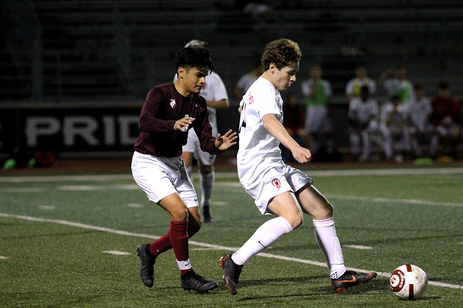 Senior Oziel Martinez (4) tries to steal the soccer ball from the opponent. 