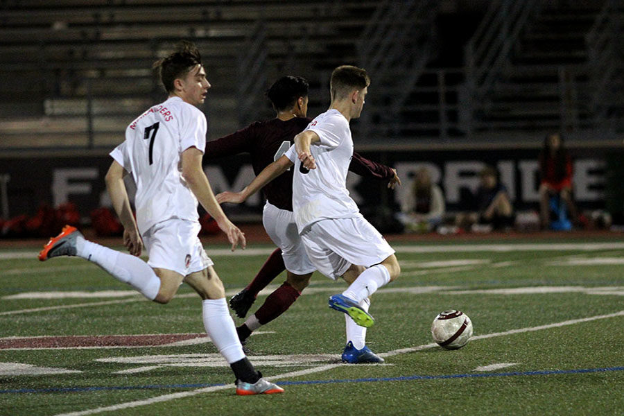 Senior Oziel Martinez (4) guards the ball against two Marcus players.