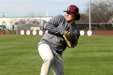 Senior captain Caleb Vuono (9) practices pitching on Wednesday, March 6 during fourth period. 