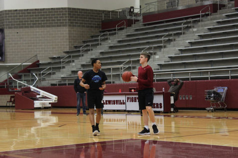 Sophomore point guard Kylin Green practices with junior shooting guard Austin Pugh on Friday, March 1. 