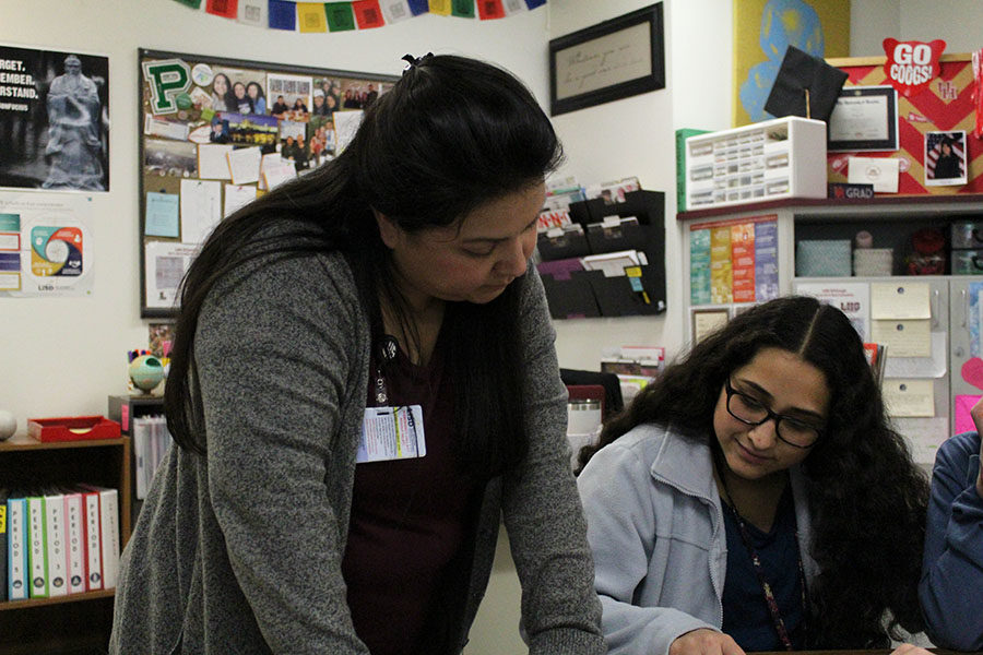 World history teacher Elizabeth Gonzalez helps sophomore Liliana Tachiquin with her essay. 