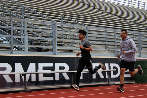 Juniors Alan Salinas and Elias Gonsalez practice during fourth period on Tuesday, March 19 for their upcoming track meet.