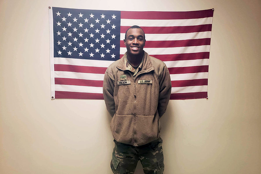 Myles Wilson poses in front of the American flag. Courtesy of Myles Wilson.