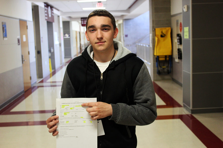Senior Dalton Baham holds his signed contract for the U.S. Army.