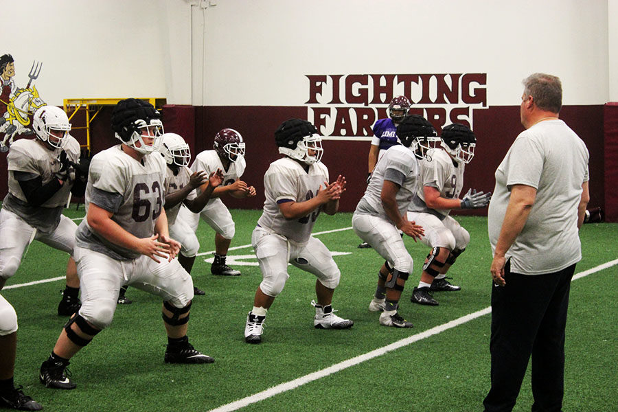 Coach Fite instructs the linemen to hold the Line during defensive plays.