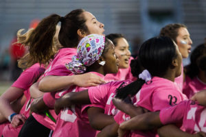 Elena Russel and other girls gather up to chant before the game begins.