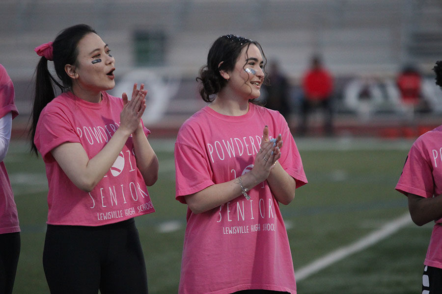 Senior Ceilia Hwang and Sloan Ibanez clap as they hear their team mates name being called.