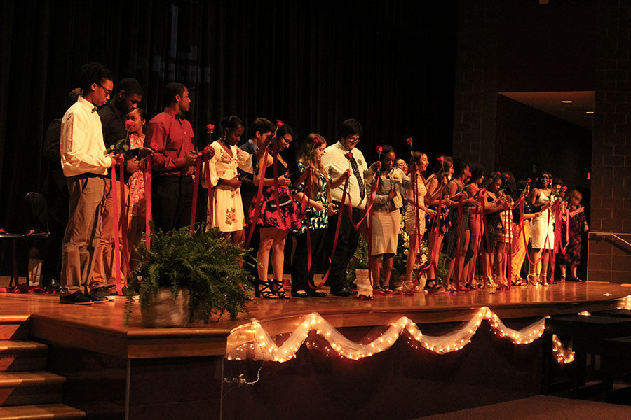 Students of the class of 2019 participate at the rosecutting ceremony on Tuesday, May 14.