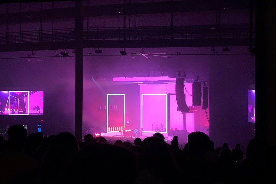 The 1975 performs TOOTIMETOOTIMETOOTIME in front of the color-changing set as fans sing along.