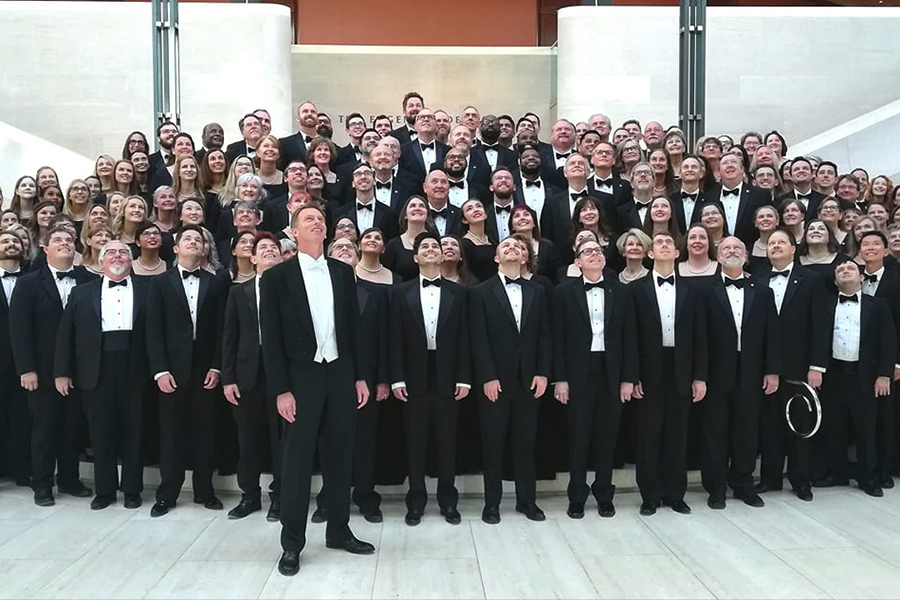 The choir section of the Dallas Symphony Chorus takes a group photo.