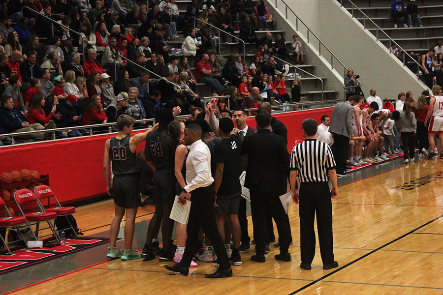 The+boys+basketball+team+huddles+together+during+the+game+against+Marcus+High+School+on+Tuesday%2C+Feb.+11.+