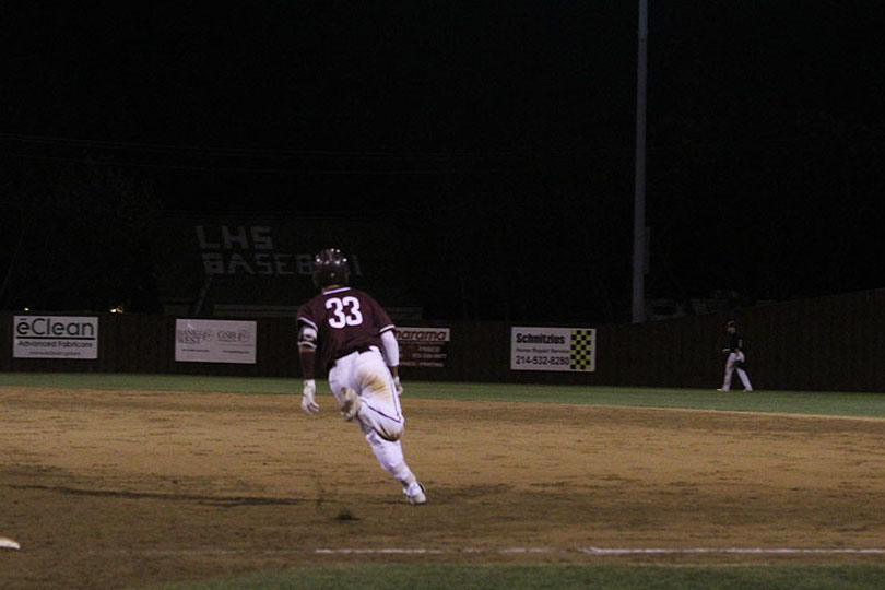 Senior Jimmy Bolton (33) makes a mad dash for second base.